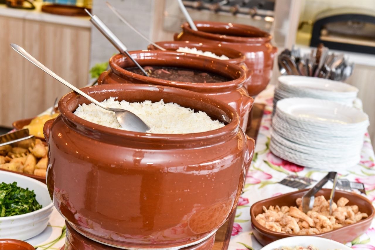Arroz e farofa acompanhando a feijoada no buffet